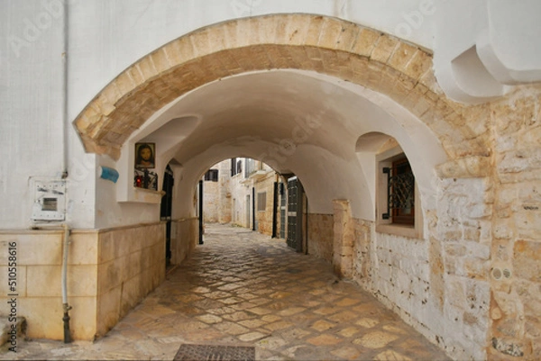 Fototapeta A small street in Casamassima, a village with blue-colored houses in the Puglia region of Italy.