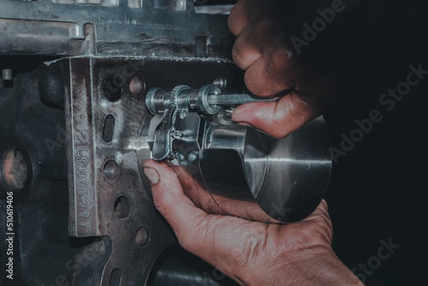 Obraz The mechanic is checking the engine.