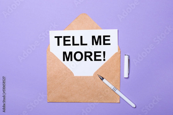 Obraz On a purple background, a white pen, a craft envelope and a white card with the text TELL ME MORE. View from above.
