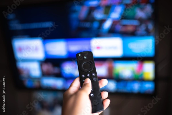 Obraz Rio de Janeiro / Brazil- February 3, 2021: amazon fire tv stick remote in hand with selective focus tv background. During the COVID-19 lockout.