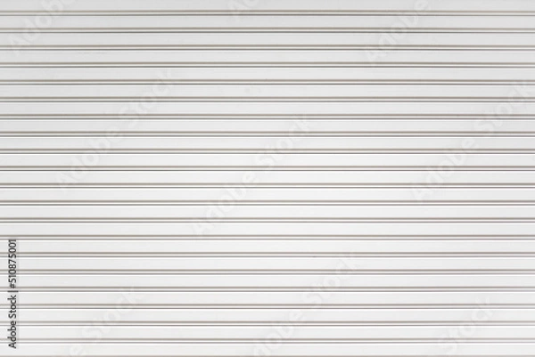 Obraz White metal roller shutter door background. Steel stripe horizontal lines of iron foldable metal sheet texture. Empty front warehouse garage abstract pattern.