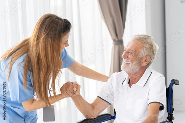 Obraz Man being cared for by a private Asian nurse at home suffering from Alzheimer's disease to closely care for elderly patients