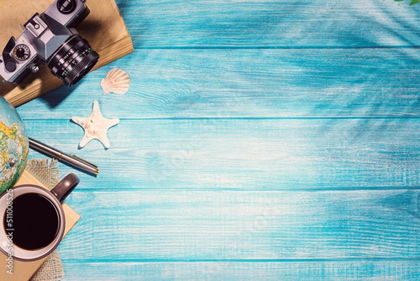 Fototapeta Top view of summer beach accessories on marine blue planks pier. Background with copy space and visible wood texture.