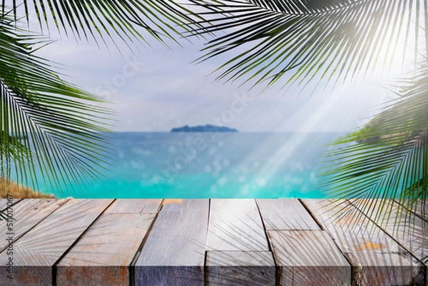 Fototapeta Wood table top and blurred summer beach and sky background, can used for display or montage