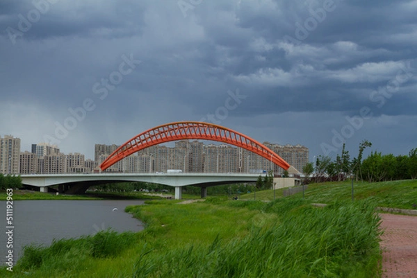 Obraz Changchun, Jilin - June 3 2021: Modern bridge by a city park in summer.