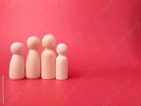 Fototapeta Wooden figures on a red background with copy space. Concept of family.