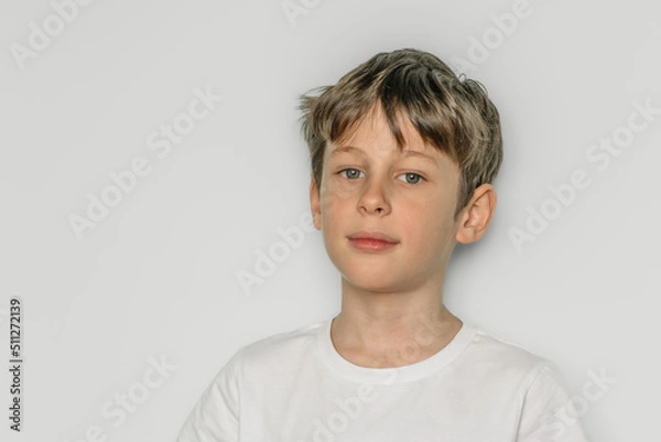 Obraz Confident boy. Portrait of a white caucasian 9 year old boy in a white t-shirt. copy space