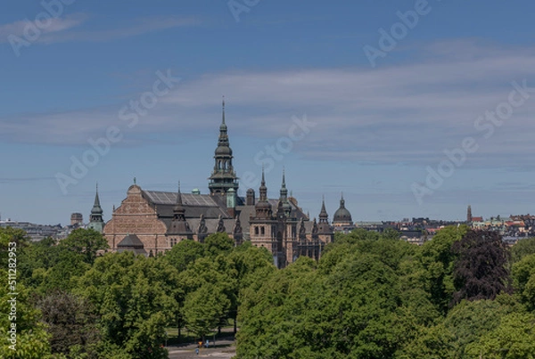 Fototapeta Old gothic museum building with towers and spires and the skyline of the districts Östermalm and Vasastan a sunny summer day in Stockholm  