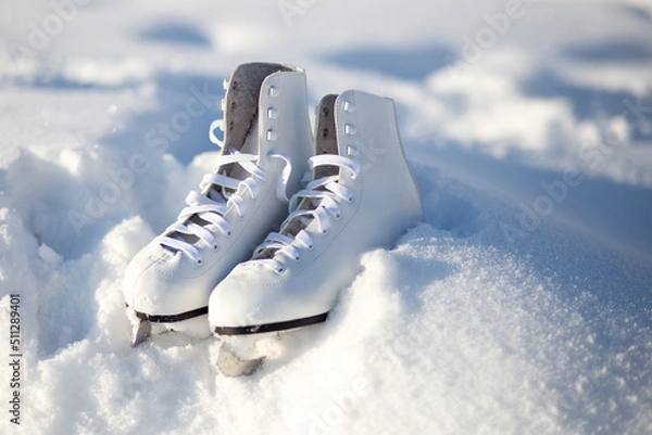 Obraz close up white leather figure skates and copy space lie on the snow