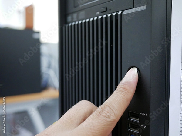Obraz finger pushing on start button office computer PC.
