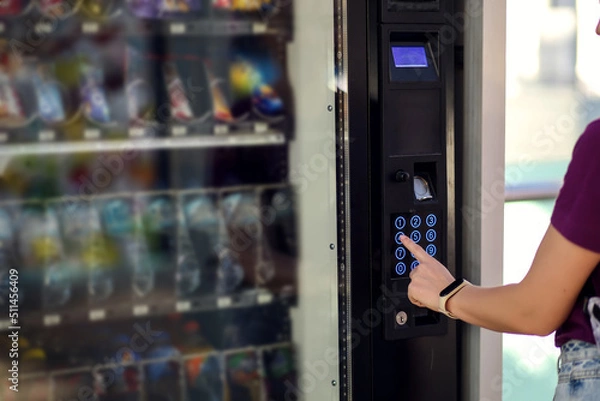 Fototapeta Hand presses button of vending machine. Self-used technology and consumption concept