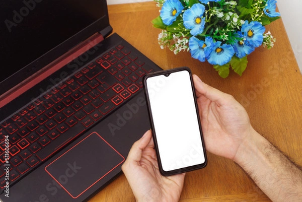 Obraz man using smartphone on his desk