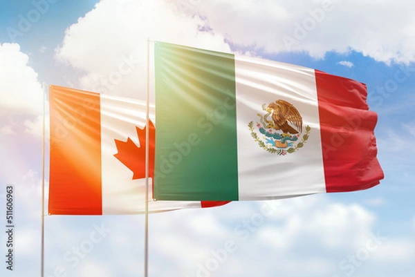 Obraz Sunny blue sky and flags of mexico and canada
