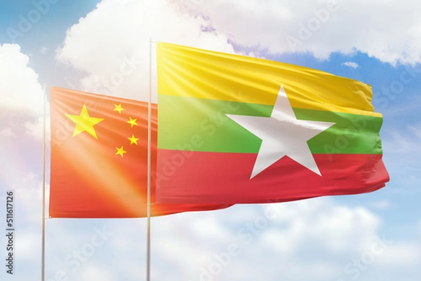 Obraz Sunny blue sky and flags of myanmar and china