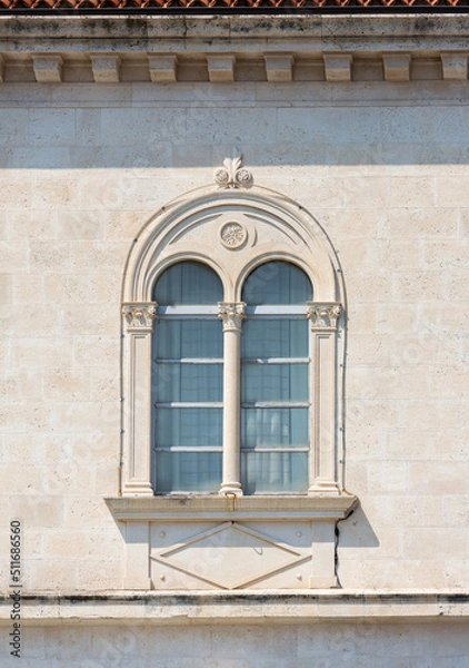 Fototapeta Fragment of the facade of a Mediterranean building with a beautiful window and relief decor