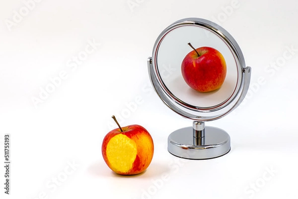 Fototapeta Apple and its reflection in a mirror on white background. Different reflection. White space for text.