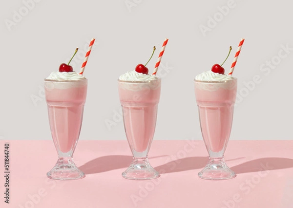 Fototapeta Retro romantic creative pattern with strawberry milkshake with cherry on top on white and pastel pink background. 70s, 80s or 90s retro fashion aesthetic idea. Valentines day romantic idea.
