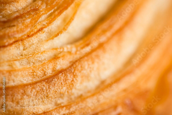 Obraz Croissant macro. French croissant with waves. Air baking. Croissant for puff pastry advertising. Croissant for a magazine.French breakfast with pastries. From puff pastry. Bun from France. Roll macro