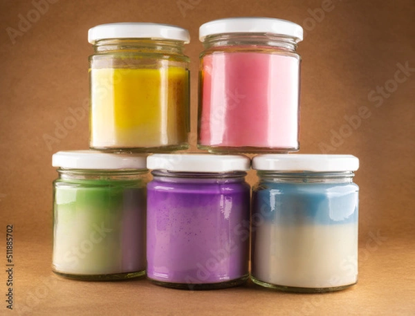 Fototapeta colorful jars with natural soy wax candles.