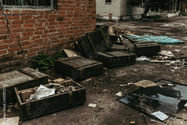 Fototapeta Boxes with weapons left by Russian troops in a Ukrainian village