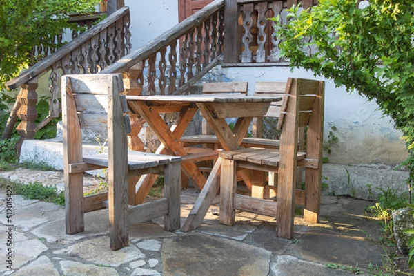 Fototapeta Beautiful shot of wooden rustic chairs and a table for garden