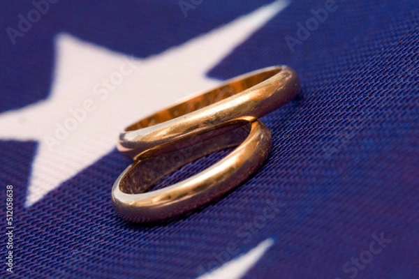Obraz two gold wedding rings on a colored background