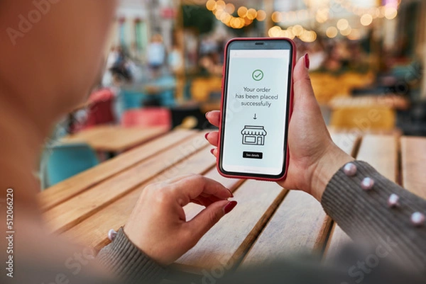 Fototapeta Online shopping. Buying product in online shop. Person paying using mobile payment app. Customer ordering item in e-shop on smartphone