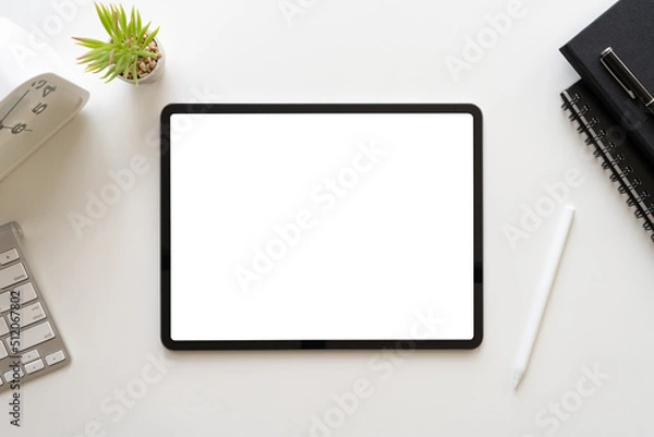 Fototapeta Top view of modern workspace white desk with blank screen tablet computer and office equipment. Table with copy space for business concept mockup template. Home workplace flat lay.