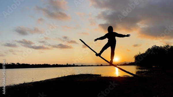 Fototapeta balancing game with energetic and unusual movements in nature
