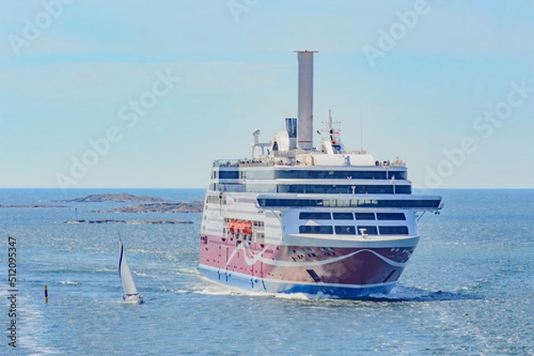 Fototapeta ships in the Baltic sea. Big ferry and a small sailboat. Blue water of the Stockholm fiord, blue sky with clouds