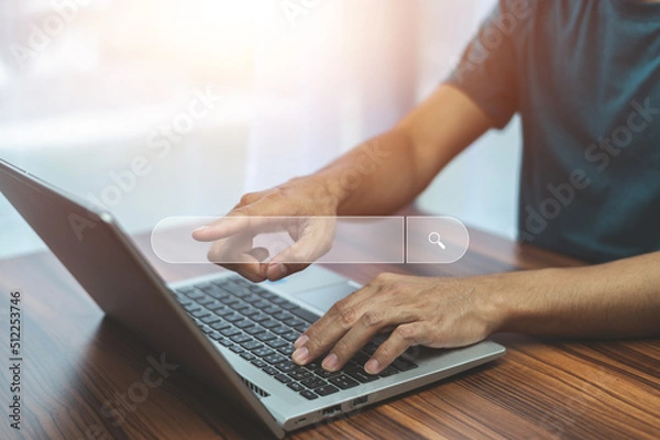 Fototapeta Man using computer search on internet Wi-Fi at home