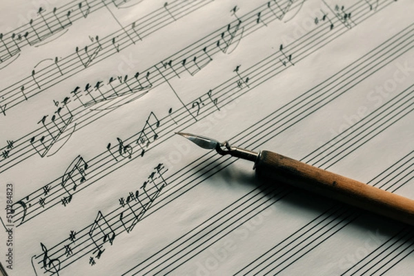 Obraz Ink pen on the background of a lined sheet with notes, writing notes, composing music
