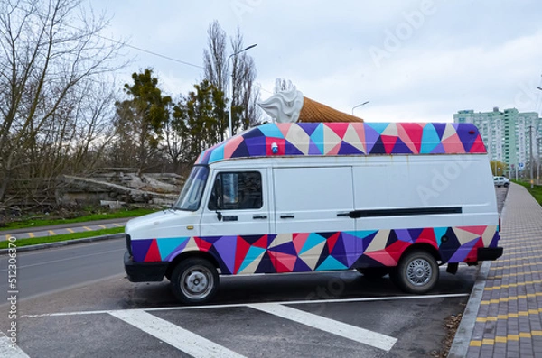 Fototapeta Bright, colorful car with a big ice cream on the roof.