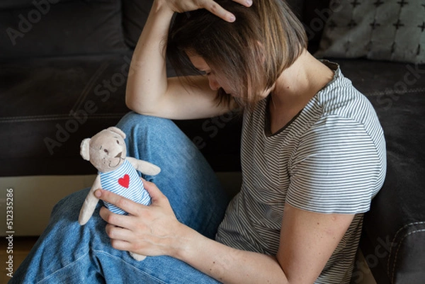 Obraz Perinatal loss reproductive chalenge concept - female holding a teddy bear toy