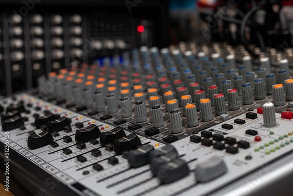 Fototapeta Close-up with selective focus of different knobs and switches of a professional sound console. Creating music, dj Concept
