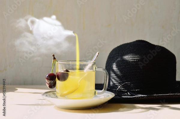 Fototapeta Surreal summer drink concept with a hand drawn white teapot flying on a cloud and pouring a yellow drink into a transparent cup with a black straw hat lying next to it.