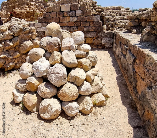 Obraz Stone balls for  catapult from the time of the Crusades in the fortress of the Crusaders in the Apollonia National Park in Israel