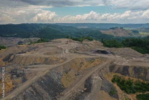Fototapeta Mountaintop Strip Mining with Green Mountains in Background with Blue Sky