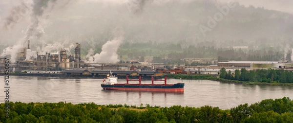 Fototapeta Columbia River at Longview, Washington. Large ship anchored in the Columbia River on a highly industrialized section near the Lewis and Clark Bridge. 
