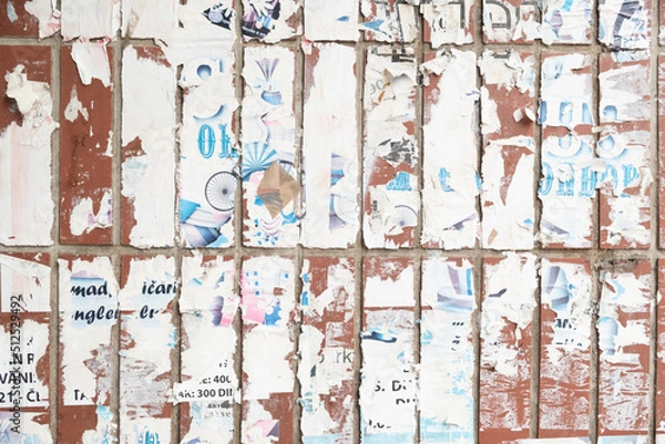Fototapeta Torn old paper poster on a brick wall background