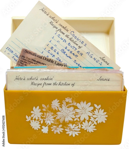 Fototapeta Old, yellow 1960s recipe box with handwritten recipes on index cards.
