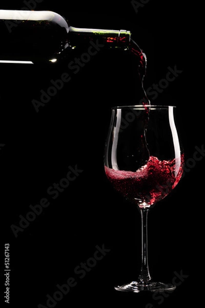 Fototapeta Red wine being poured into a glass