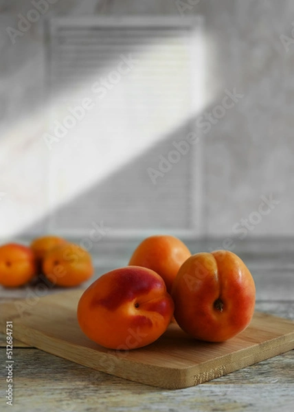 Fototapeta Fresh ripe apricots on a wooden background, copy space. Apricots are rich in vitamins and minerals such as: vitamin A, beta-carotene, vitamin C, potassium, silicon, cobalt, manganese, copper