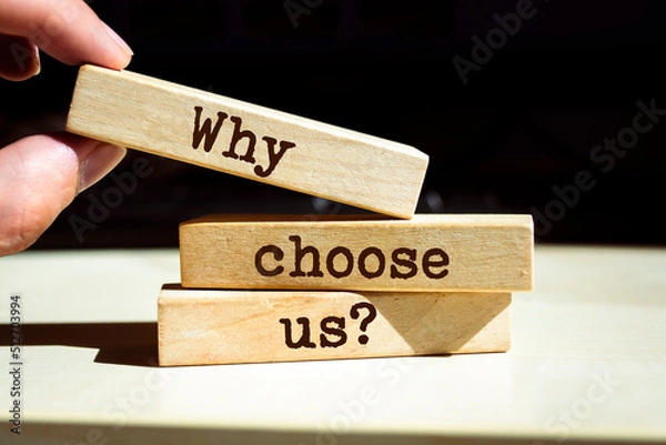 Fototapeta Businessman puts wooden blocks with the words Why Choose Us Question.