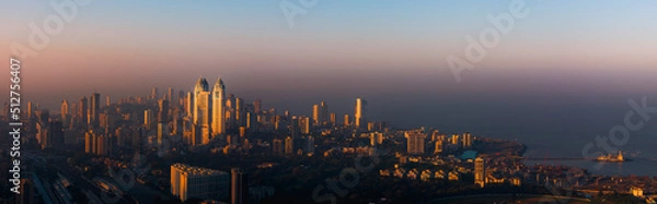 Fototapeta The glow of Mumbai at dawn. This is the skyline of Mumbai lit up by the first sun rays of the day.