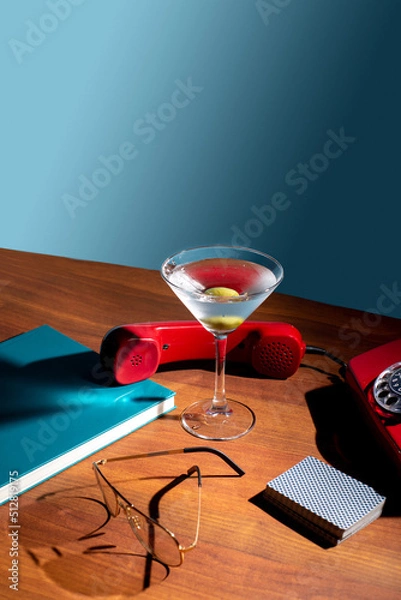 Fototapeta Cocktail in a tall glass for vermouth on the background of retro things. Concept of mixology and bartending