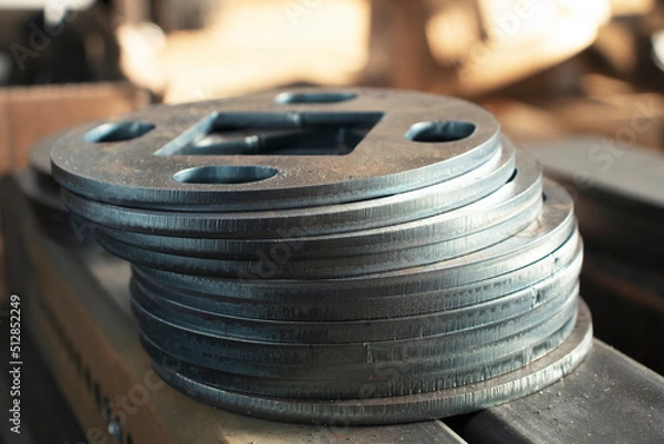 Obraz Round metal products from sheet steel cut on CNC plasma cutting machine, metalworking close-up at the factory