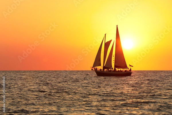 Obraz sail boat silhouette in the sun set at the beach