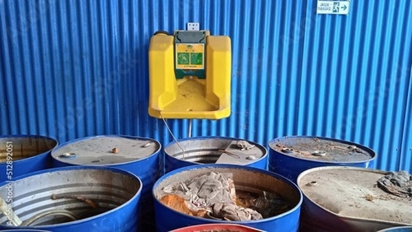 Obraz Eye wash device that mounted on a blue wall. That place is hazardous waste storage
