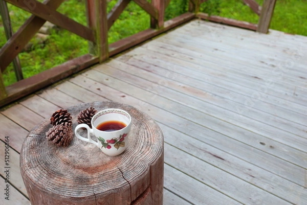 Obraz Pinecones and tea  on stump